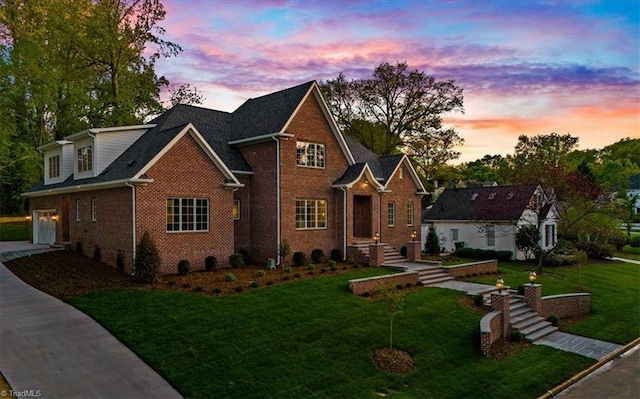 905 Brookside Dr, Greensboro, NC 27408 - traditional home featuring a lawn, brick siding, and concrete driveway