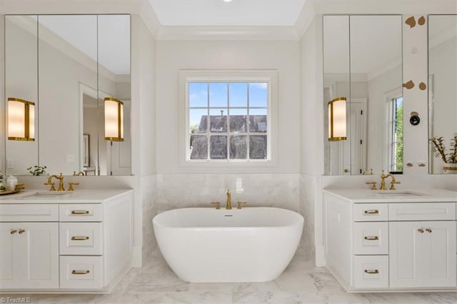 905 Brookside Dr, Greensboro, NC 27408 - bathroom featuring a healthy amount of sunlight, marble finish floor, ornamental molding, and a sink