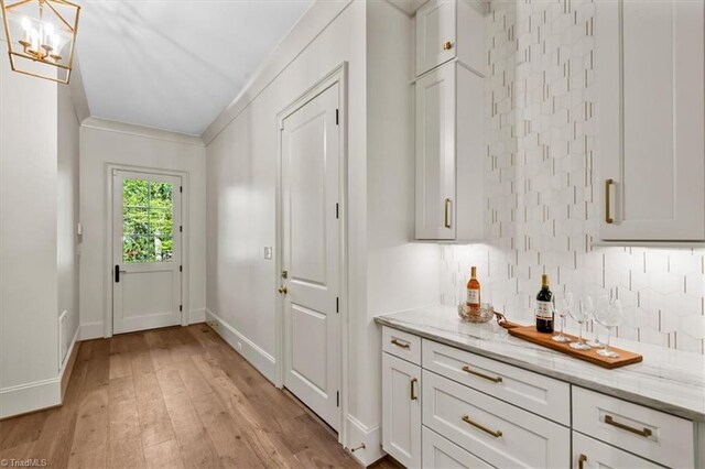 905 Brookside Dr, Greensboro, NC 27408 - entryway with baseboards, a chandelier, and light wood-style flooring