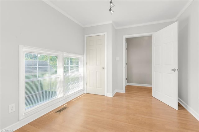 interior space featuring light hardwood / wood-style floors and crown molding