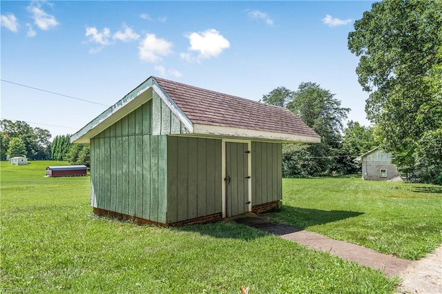 view of outdoor structure featuring a lawn