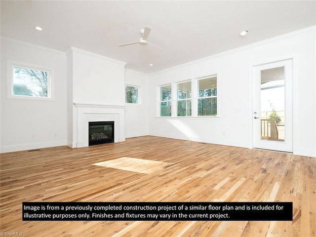 unfurnished living room featuring crown molding, plenty of natural light, ceiling fan, and wood-type flooring