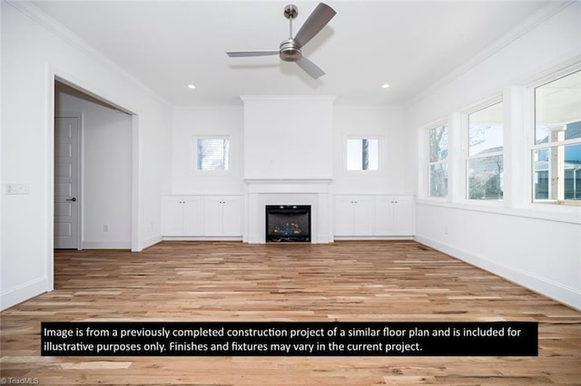 unfurnished living room featuring light hardwood / wood-style flooring, a wealth of natural light, and crown molding