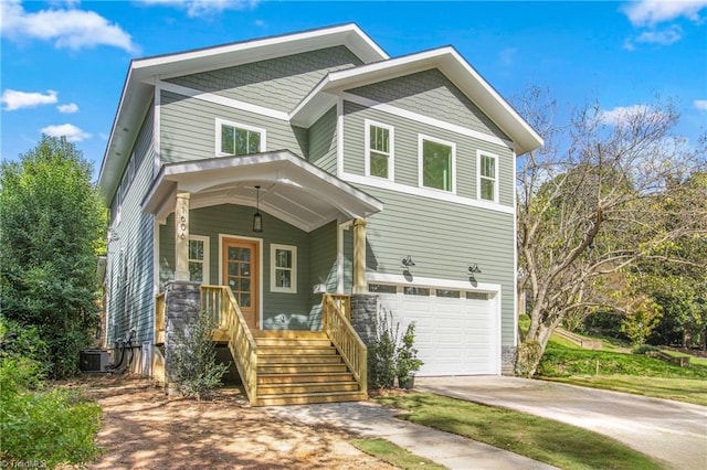 view of front of house with a garage and central AC