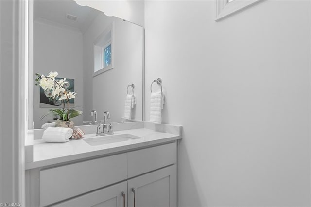 bathroom featuring vanity and ornamental molding