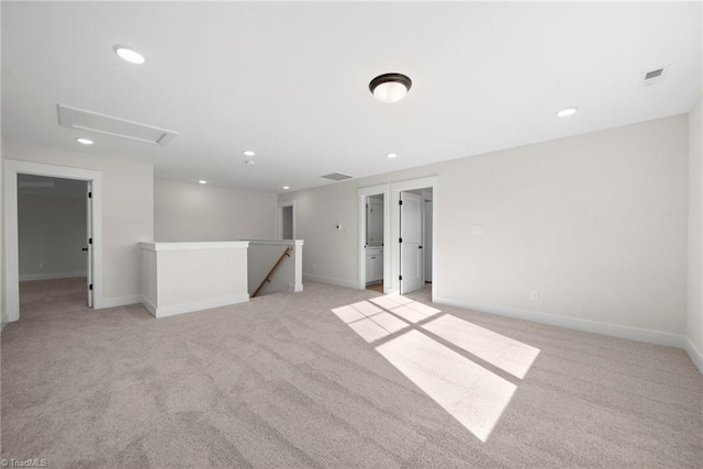 unfurnished room featuring light carpet, baseboards, and recessed lighting