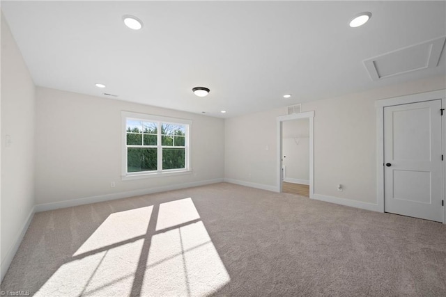 unfurnished room featuring recessed lighting, baseboards, and light carpet