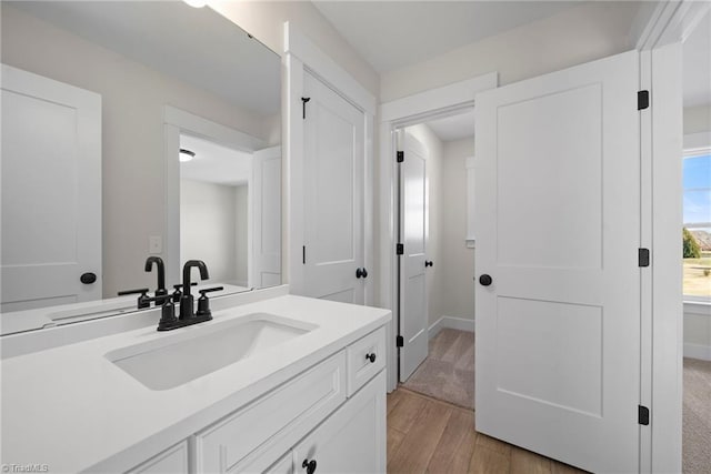 bathroom with wood finished floors and vanity