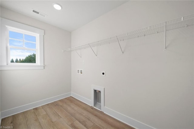 laundry area featuring electric dryer hookup, laundry area, baseboards, visible vents, and washer hookup