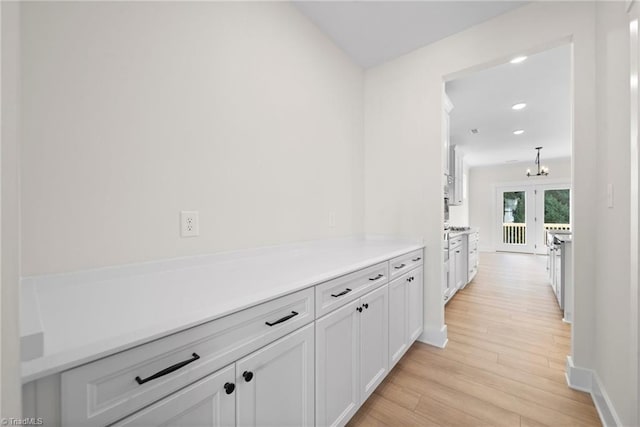 hall featuring recessed lighting, baseboards, french doors, and light wood-style flooring