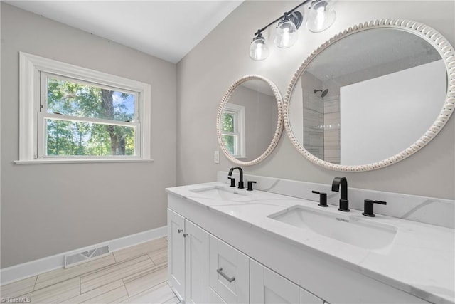 bathroom with vanity, a shower, and tile patterned floors