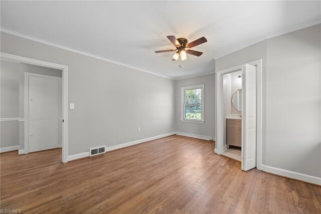 unfurnished bedroom featuring crown molding, ensuite bathroom, ceiling fan, and light hardwood / wood-style floors