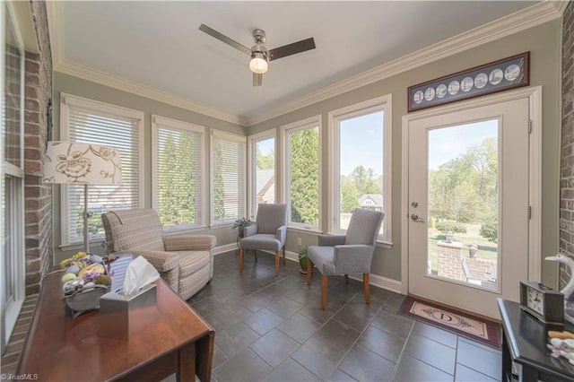 sunroom with baseboards, ornamental molding, and stone tile floors