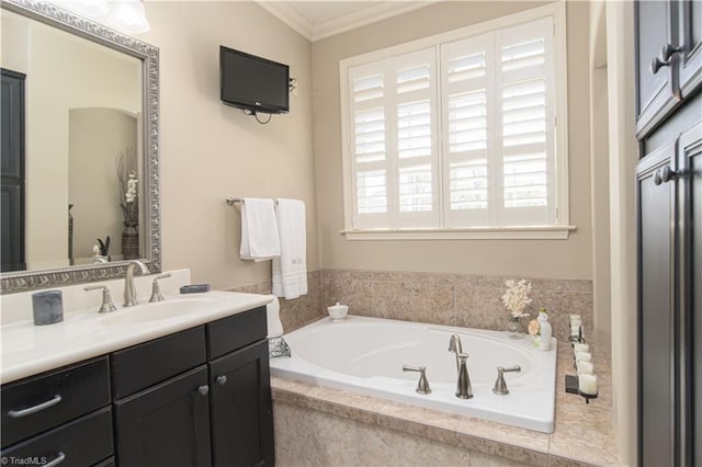 bathroom with a bath, vanity, and ornamental molding