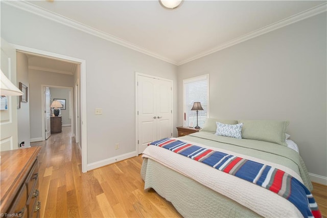 bedroom featuring light wood-style floors, baseboards, and ornamental molding