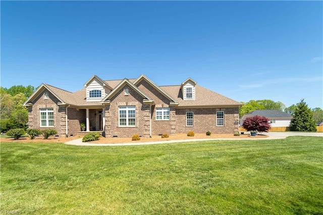 craftsman house with a front lawn and brick siding