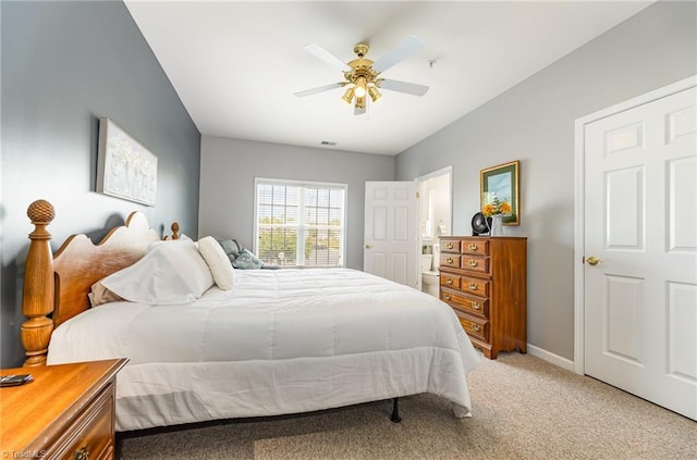 bedroom featuring a ceiling fan, baseboards, and light colored carpet