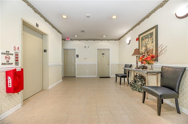 hallway featuring recessed lighting, elevator, wainscoting, and baseboards