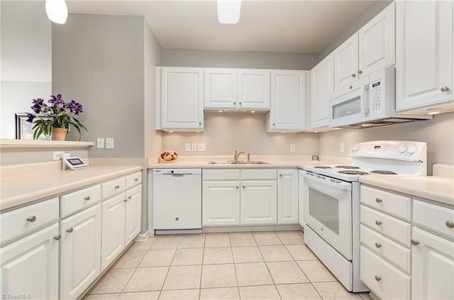 kitchen with white appliances, light tile patterned flooring, white cabinetry, and light countertops