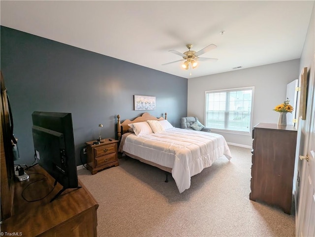 carpeted bedroom with a ceiling fan, baseboards, and visible vents