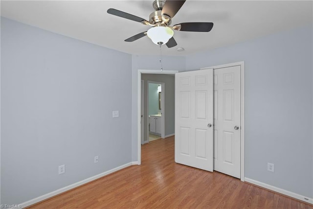 unfurnished bedroom with a closet, baseboards, ceiling fan, and light wood finished floors