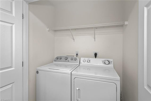 laundry room with washing machine and clothes dryer and laundry area