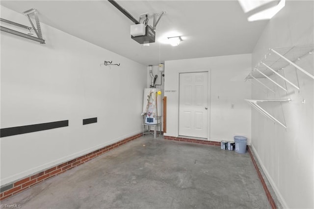 garage featuring gas water heater, baseboards, and a garage door opener