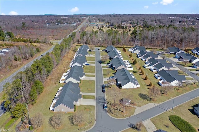 birds eye view of property with a residential view and a wooded view