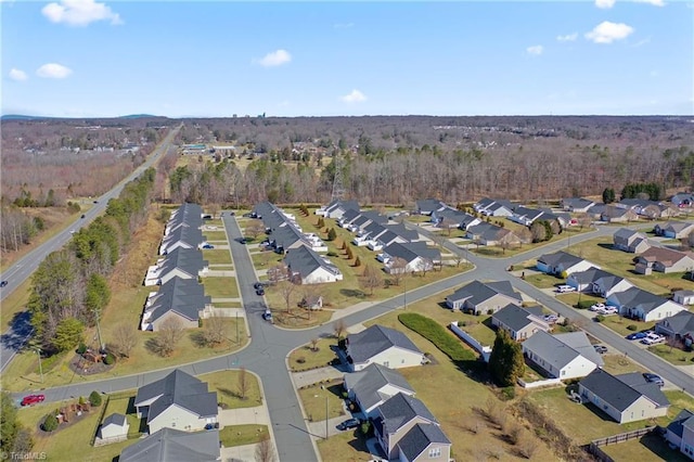 aerial view featuring a view of trees and a residential view