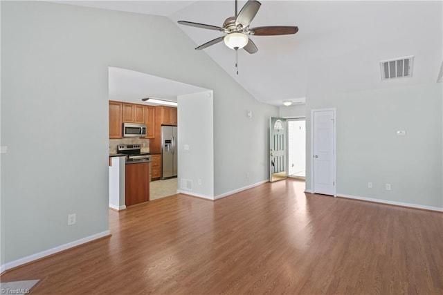 unfurnished living room with baseboards, visible vents, a ceiling fan, and light wood-style floors