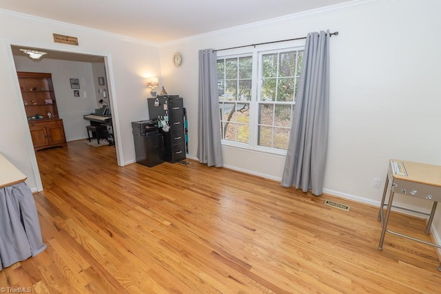 spare room featuring light hardwood / wood-style floors and ornamental molding