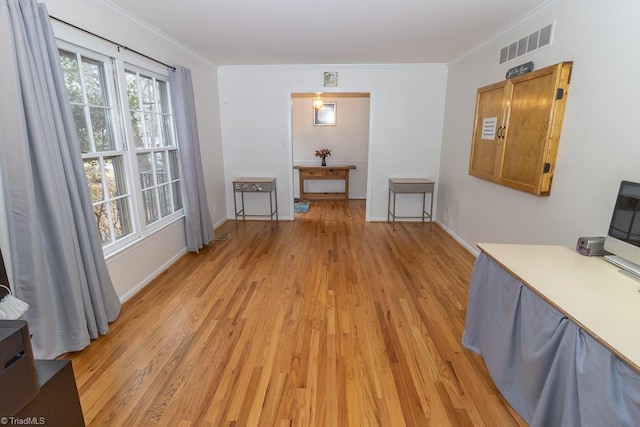 interior space with light hardwood / wood-style flooring and ornamental molding