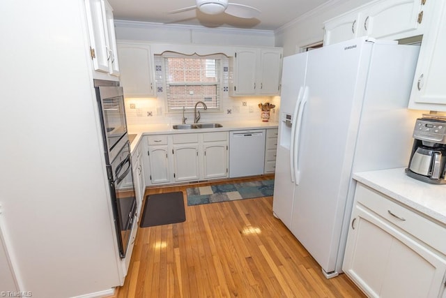 kitchen with ceiling fan, sink, light hardwood / wood-style floors, white appliances, and white cabinets