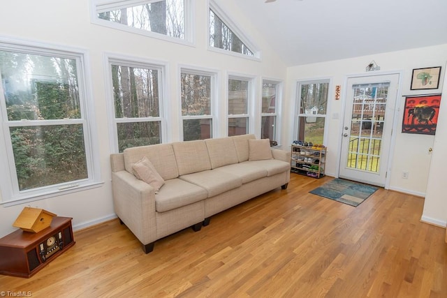 sunroom / solarium featuring lofted ceiling