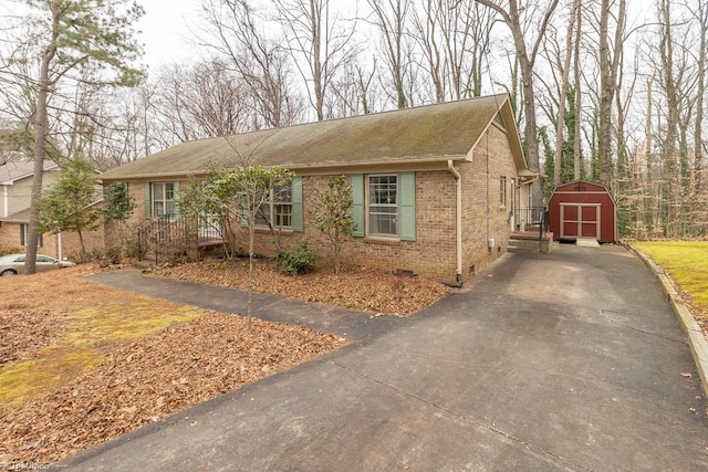 single story home featuring a storage shed