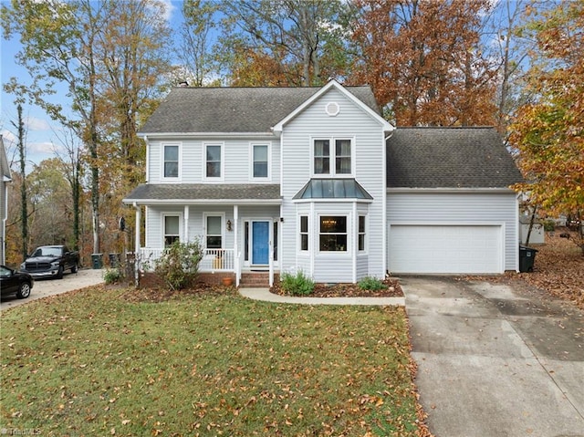 front facade featuring covered porch, a garage, and a front lawn