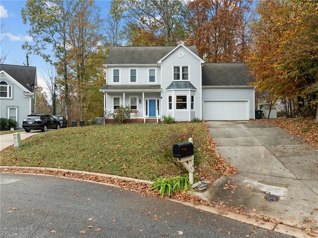 front of property with a front lawn, a porch, and a garage