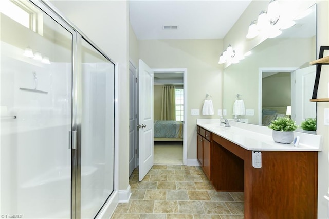 bathroom with vanity and a shower with shower door