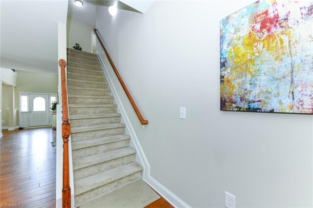 staircase with hardwood / wood-style flooring