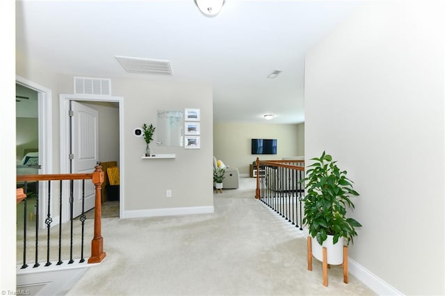 hallway featuring light carpet