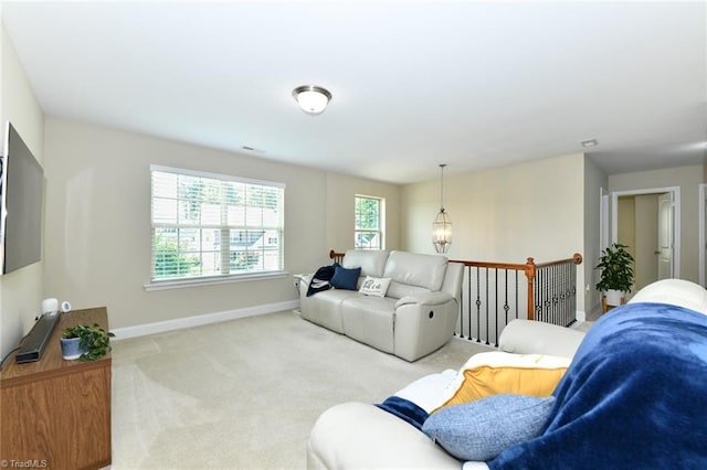 living room with a chandelier and light colored carpet