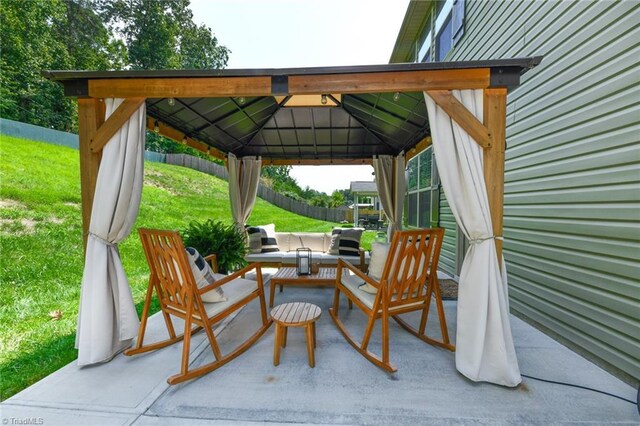 view of patio featuring an outdoor living space and a gazebo