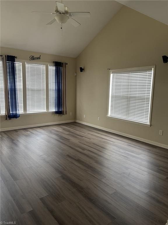 unfurnished room with dark wood-style flooring, vaulted ceiling, baseboards, and ceiling fan