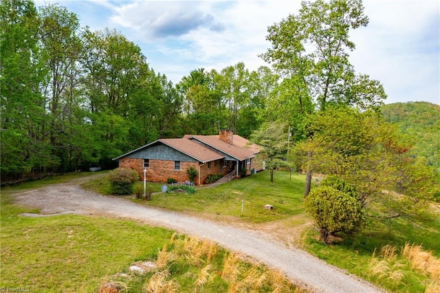 drone / aerial view featuring a view of trees