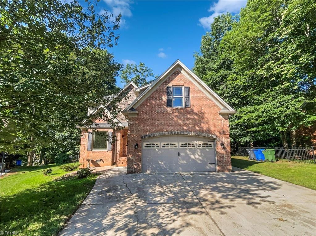 350 Bent Creek Trl, Kernersville, NC 27284 - traditional-style house featuring concrete driveway, a garage, and brick siding