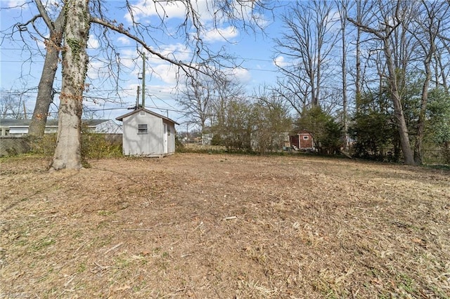 view of yard with an outdoor structure and a shed