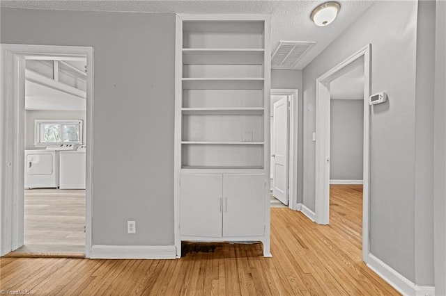 closet with separate washer and dryer and visible vents