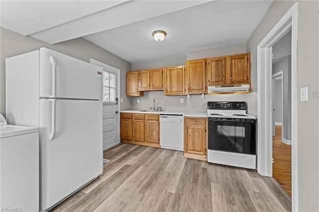 kitchen featuring white appliances, washer / dryer, light wood-style floors, light countertops, and under cabinet range hood