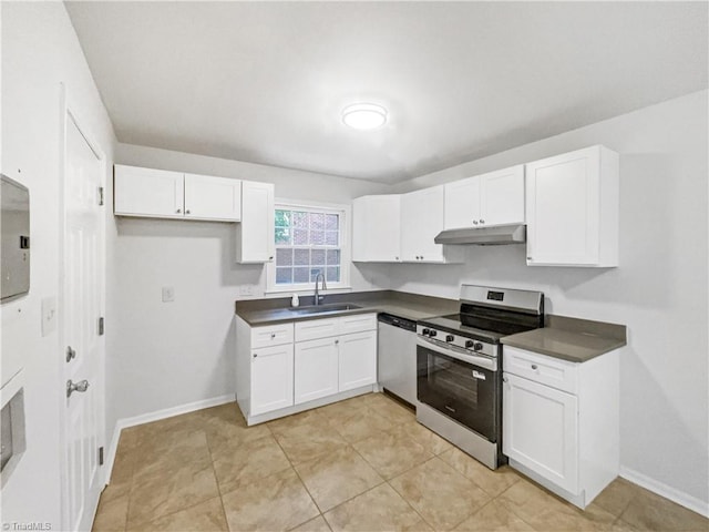 1606 Woodbriar Ave, Greensboro, NC 27405 - kitchen with appliances with stainless steel finishes, under cabinet range hood, dark countertops, and white cabinets