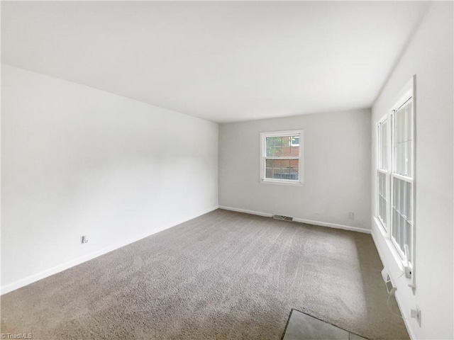1606 Woodbriar Ave, Greensboro, NC 27405 - spare room featuring carpet flooring and baseboards
